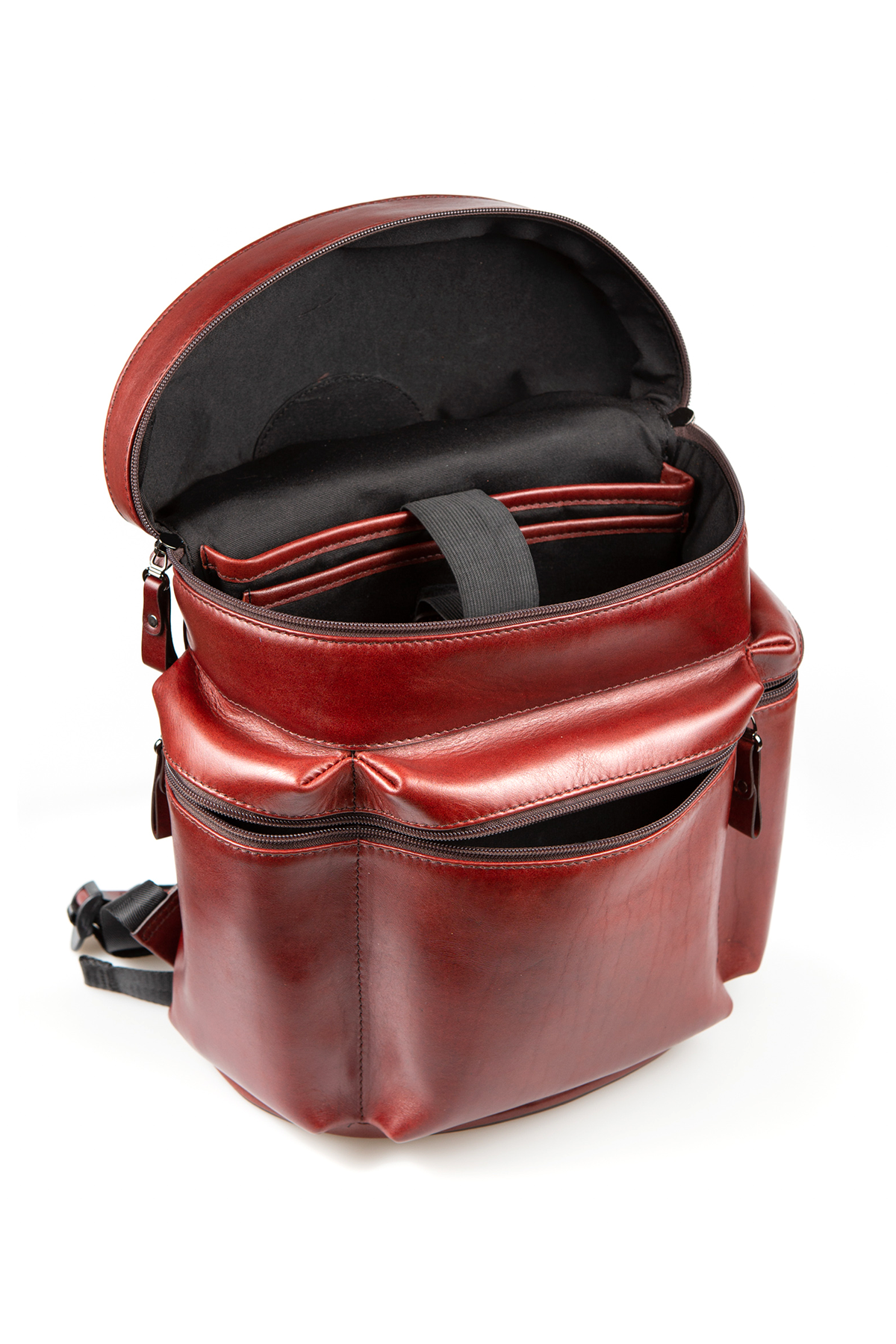 A genuine leather backpack with the top unzipped and open